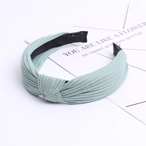 Knitted cotton wide knot headband in light mint green with pleated fabric texture