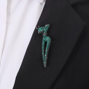 Minimalist giraffe brooch with green crystals pinned on a professional black suit lapel