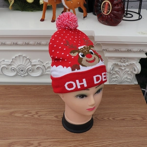 Detail of red knit Christmas hat with LED lights, reindeer patterns and OH DEER text