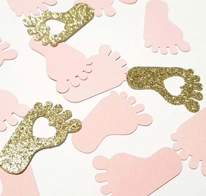 Pink baby feet confetti and gold glitter hollow heart cutouts for gender reveal decor