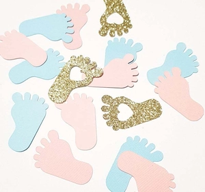 Baby feet shaped confetti in pink, blue and gold glitter for gender reveal party table
