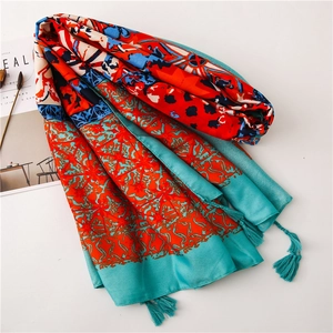 Detailed view of bohemian floral print scarf with soft tassels and ethnic geometric patterns