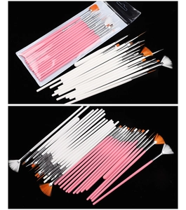 Detailed set of professional nail art brushes with pink and white handles on black background