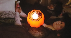Detail of LED pumpkin candle lamp with spider web pattern for Halloween decor