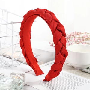 Bright red twisted braid headband in textured fabric with a high-top fashion design