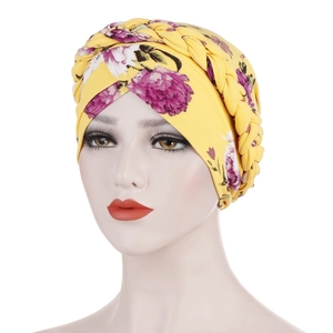 Detail of yellow floral turban hat featuring braided design and soft milk silk fabric