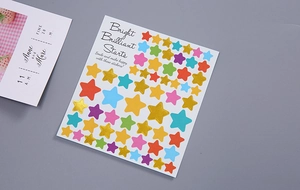 Close-up of colorful gold foil star stickers for scrapbooking and DIY craft decoration
