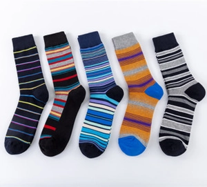 Flat lay of colorful striped men's casual socks in various diverse color patterns