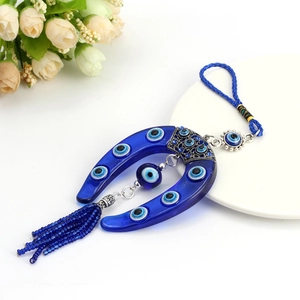 Blue Turkish evil eye horseshoe pendant with elegant tassels for luck and home decor