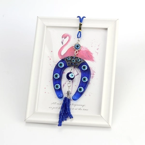 Lucky Evil Eye horseshoe wall hanging with blue glass beads and decorative fringe