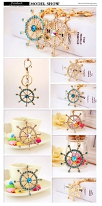 Detail of nautical ship wheel keychain with sparkling blue and colorful rhinestones