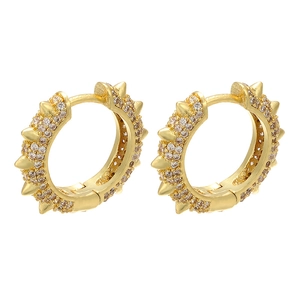 Gold spike hoop earrings with pavé white cubic zirconia crystals on white background
