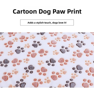 Close-up detail of soft flannel pet blanket with grey and orange cartoon paw prints