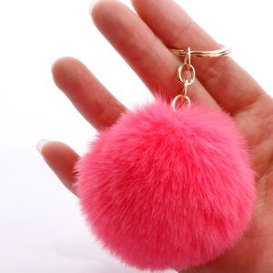 7cm rose pink faux rabbit fur pom pom keychain with gold ring held in hand