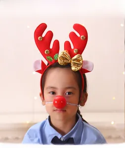 Close-up of reindeer antlers headband and red nose accessory for Christmas costumes