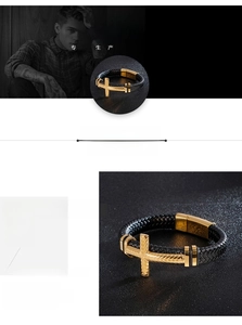 Detail of men's black braided leather bracelet with gold stainless steel cross charm
