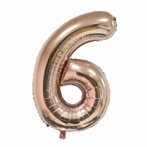 Detail of rose gold number 6 foil balloon with metallic finish for birthday parties