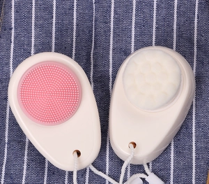 Dual-sided silicone face brush with soft bristles and hanging rope detail view
