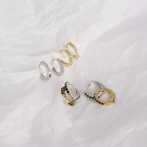 Close-up of S925 silver huggie earrings with micro-set white and black zircon stones