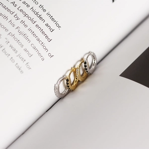Macro shot of silver and gold S925 sterling silver huggie earrings with micro-set zircons