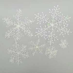 Close-up of six iridescent glitter snowflake ornaments in various sizes for tree decor