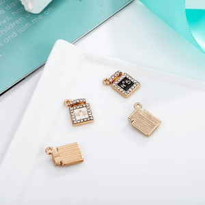 Detailed close-up of perfume bottle shaped alloy pendants with rhinestones and N5 engraving