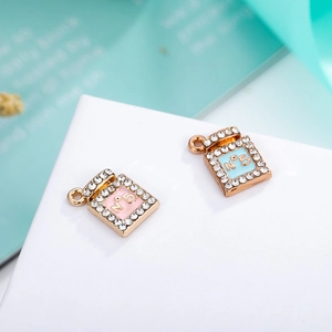 Macro shot of gold-plated perfume bottle pendants with N5 design and rhinestones