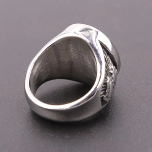 Macro view of brushed stainless steel praying hand ring with detailed carved textures