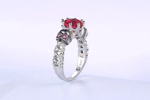 Detail of 18K GP engraving on the band with red stone and skull accents