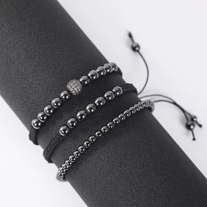 Detailed view of three adjustable black hematite beaded bracelets on a display stand
