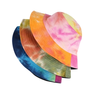 Set of three colorful tie-dye bucket hats in pink, orange and blue on white background