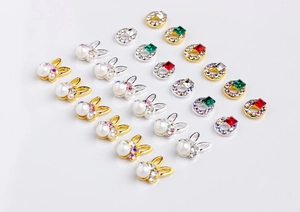 Detailed grid of bunny nail charms and square gemstones with colorful rhinestones