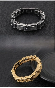 Detail view of steel motorcycle chain bracelets in gold and vintage silver with rhinestones