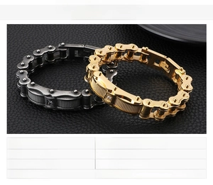 Detail of gold and gunmetal motorcycle chain bracelets with cubic zirconia on black leather