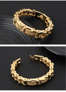 Detail of gold titanium steel men's bracelet with mechanical links and center diamond
