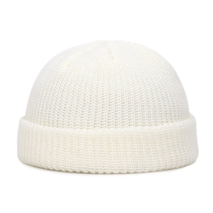 Close-up of knit texture and folded cuff on cream white winter beanie hat