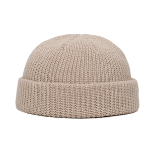 Detailed view of the fine beige knit texture and premium yarn on this skull cap