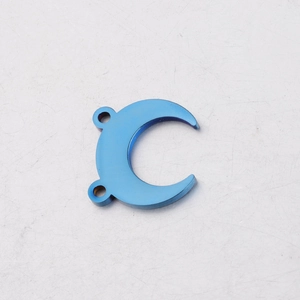 Macro detail of a blue crescent moon pendant in titanium steel with dual connector holes