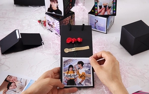 DIY black explosion gift box set with gold label and red floral accents for photos