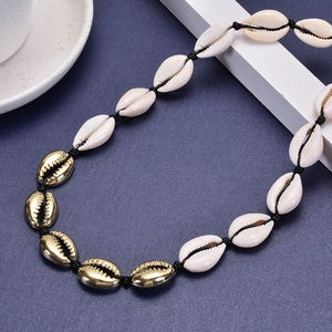 Bohemian gold shell necklace with natural white cowrie beads on black braided rope