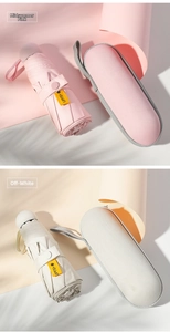 Close-up of pink and beige mini umbrellas with UV UPF50+ labels and hard travel cases
