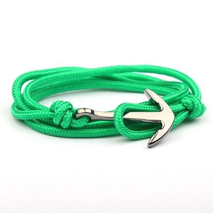 Detailed shot of a green braided nylon rope bracelet with a silver anchor clasp closure