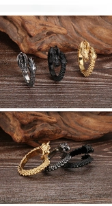 Detail of vintage dragon rings in gold black and silver with scaled texture