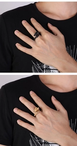 Detailed view of adjustable dragon rings in black and gold finish with scaled texture