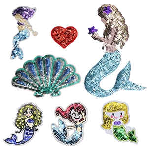 Detail of colorful sequined mermaid patches and sea shells for DIY clothing decoration