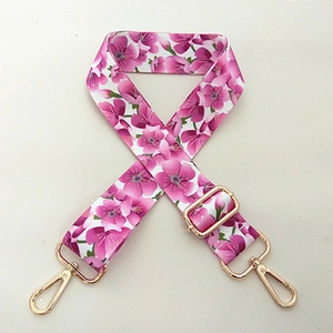 Adjustable crossbody shoulder strap with pink cherry blossom pattern and gold metal hardware
