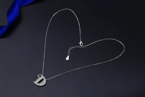 Detailed view of D-letter pendant necklace with S925 silver finish and shimmering zircon stones