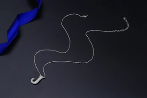 Detail view of S925 sterling silver letter J pendant necklace with white zircon stones