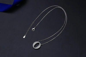 Detailed close-up of S925 sterling silver stamp on a cubic zirconia alphabet necklace