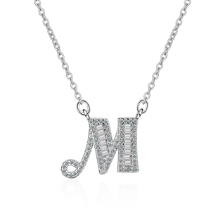 Detailed view of silver letter M necklace pendant with baguette-cut zircons on cable chain
